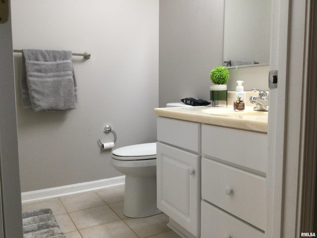 half bath featuring baseboards, vanity, toilet, and tile patterned floors