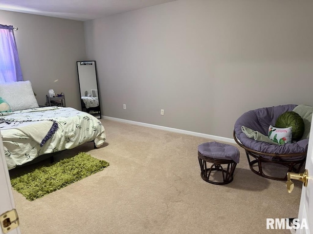 bedroom with light carpet and baseboards