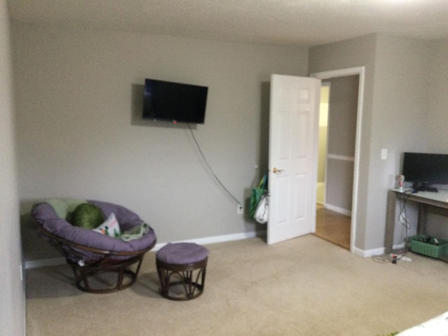 sitting room with carpet flooring and baseboards