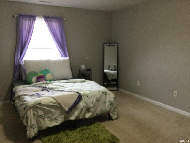 bedroom featuring baseboards and light colored carpet