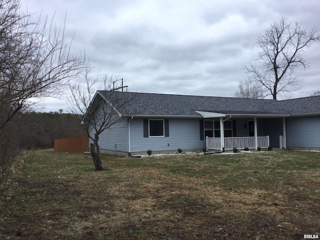 single story home with a porch, a front yard, and a shingled roof