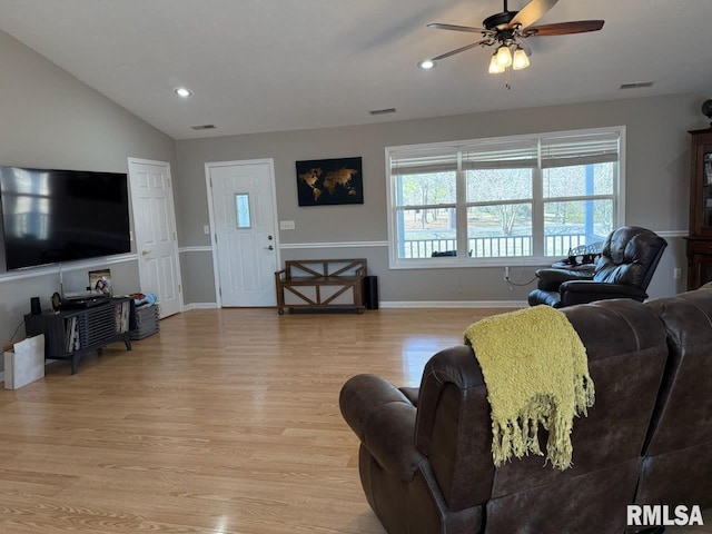 living room featuring light wood finished floors, lofted ceiling, recessed lighting, visible vents, and baseboards