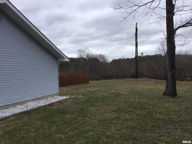 view of yard featuring fence and a view of trees