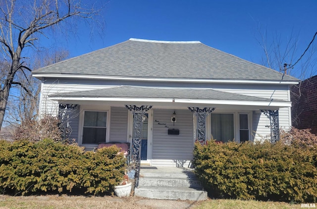 view of front facade featuring a porch and roof with shingles