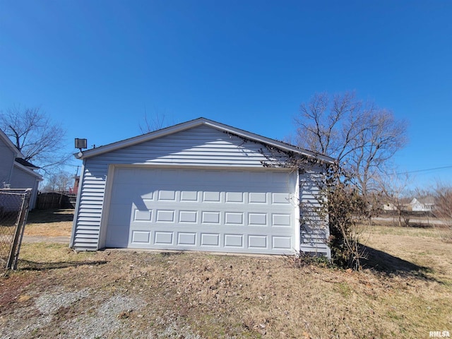 detached garage featuring fence