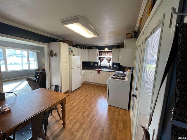 kitchen with ornamental molding, white appliances, white cabinetry, and light wood-style floors