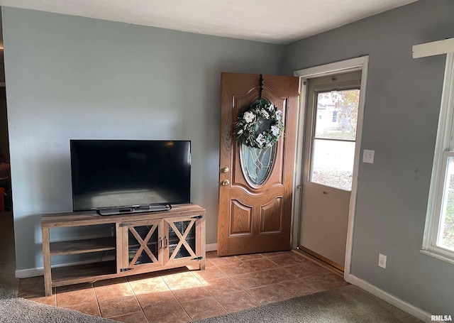 entrance foyer with tile patterned flooring and baseboards