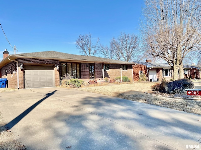 single story home featuring a garage, brick siding, driveway, and a chimney