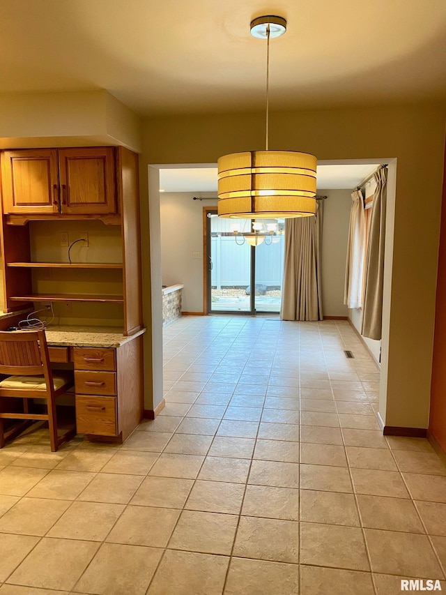 kitchen with open shelves, light tile patterned flooring, visible vents, and baseboards