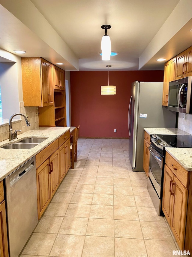 kitchen featuring light tile patterned floors, a sink, light stone countertops, stainless steel appliances, and backsplash