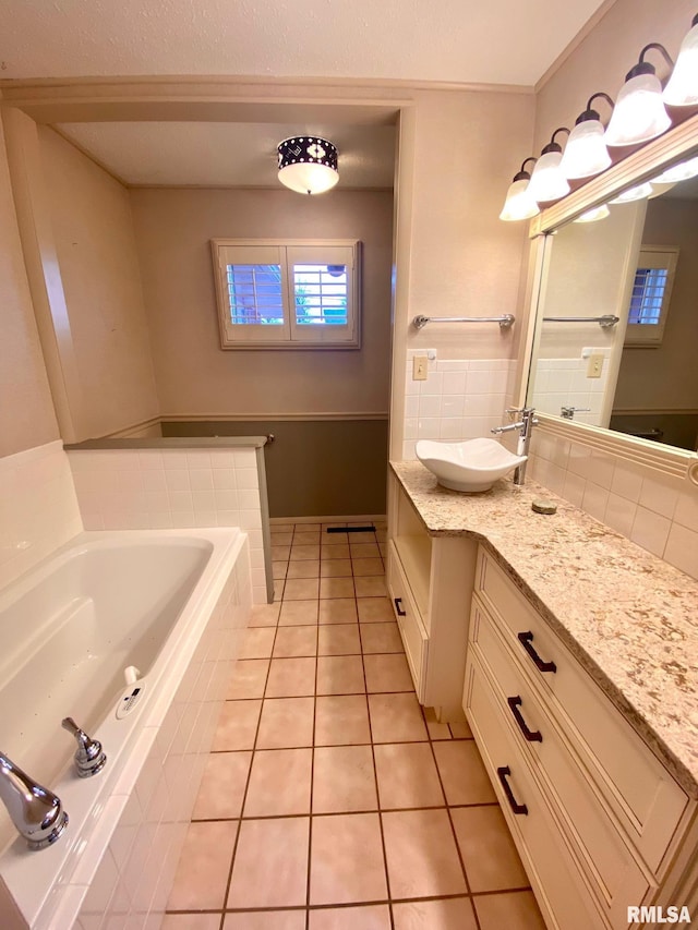 bathroom with vanity, a bath, and tile patterned floors