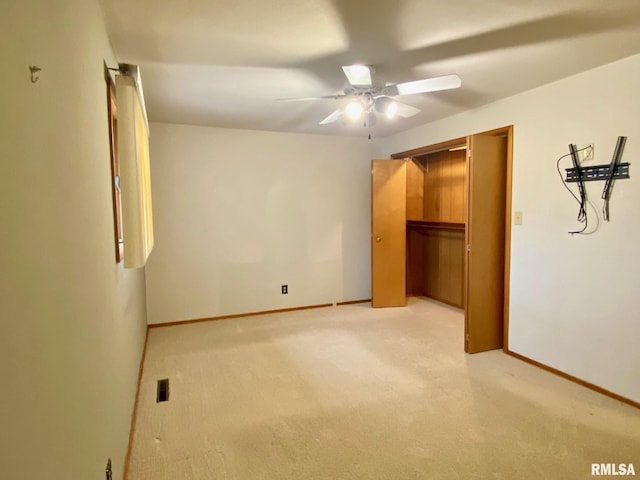 unfurnished bedroom with light carpet, ceiling fan, visible vents, and baseboards