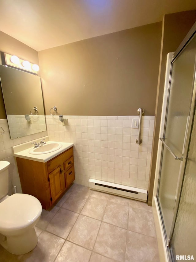 full bath with a baseboard radiator, vanity, tile walls, and a shower stall