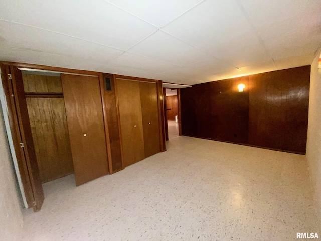 interior space with wooden walls and two closets