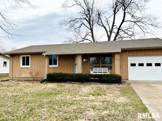 ranch-style home featuring roof with shingles, concrete driveway, board and batten siding, a garage, and a front lawn