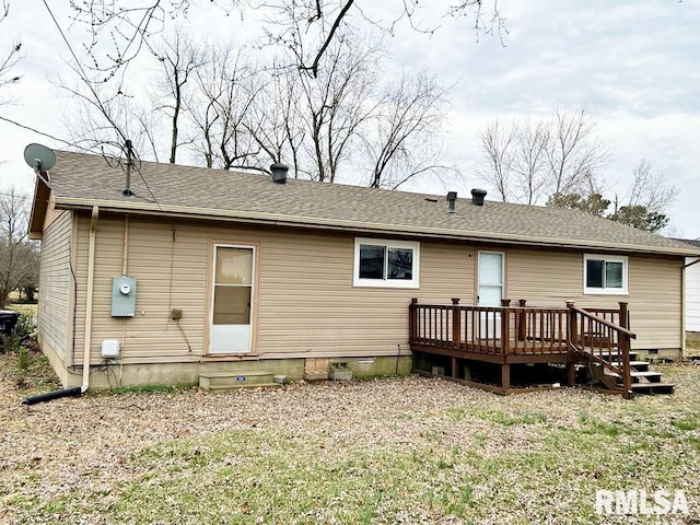 rear view of house with crawl space, entry steps, a deck, and roof with shingles