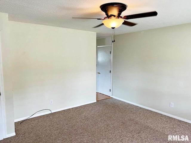 unfurnished room with carpet floors, a textured ceiling, baseboards, and a ceiling fan