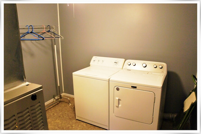 laundry room with laundry area, separate washer and dryer, and baseboards