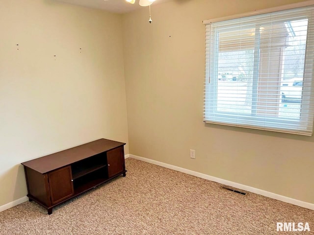 interior space with light carpet, visible vents, and baseboards