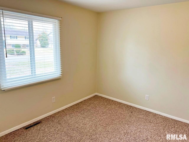 carpeted empty room with baseboards and visible vents