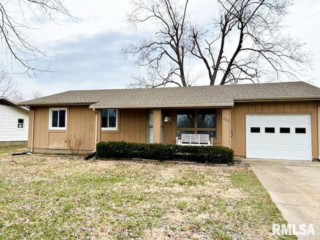 single story home featuring an attached garage, a front lawn, board and batten siding, and concrete driveway