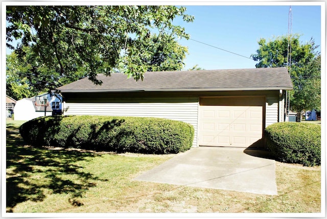 exterior space featuring a front yard, roof with shingles, and driveway