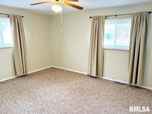 carpeted empty room with baseboards and a ceiling fan