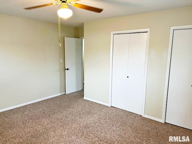 unfurnished bedroom featuring ceiling fan, multiple closets, carpet, and baseboards