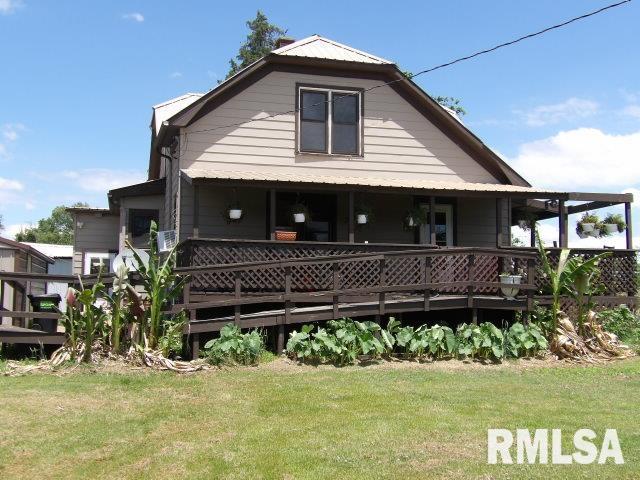 back of property featuring a yard and a wooden deck