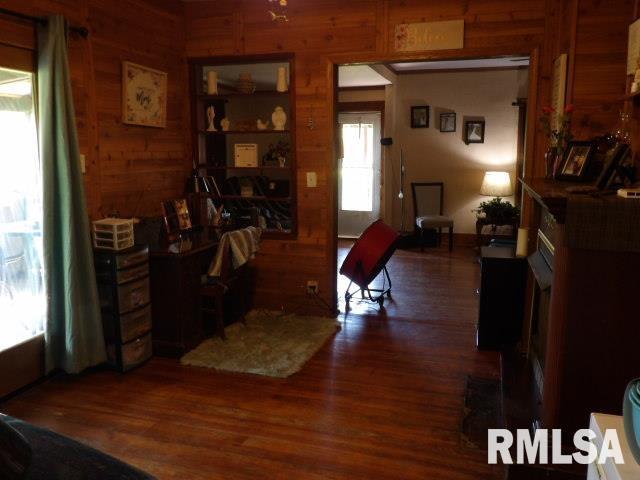 home office featuring wood walls and wood finished floors