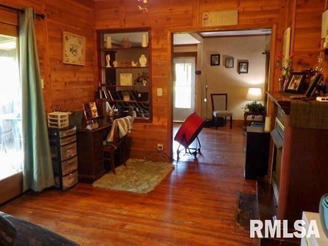 office area with wood walls and wood finished floors