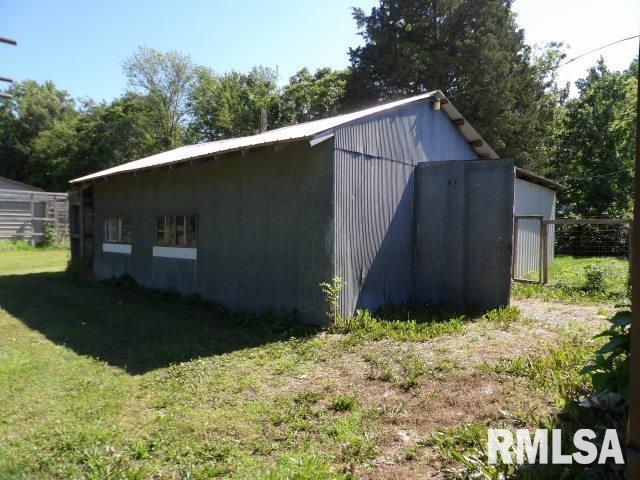 view of pole building with a lawn