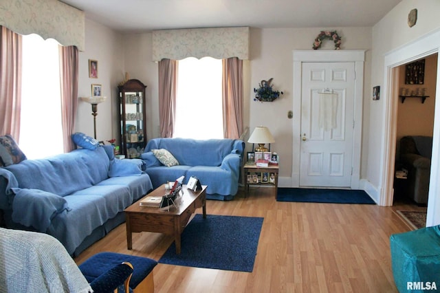 living room featuring light wood-type flooring and baseboards