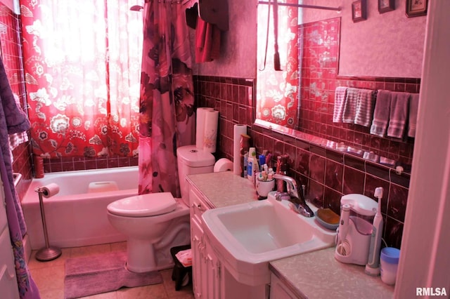 bathroom featuring toilet, shower / tub combo, vanity, tile walls, and tile patterned floors