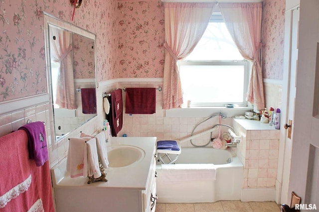 bathroom with a wainscoted wall and wallpapered walls