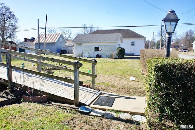 view of yard featuring fence and an outdoor structure