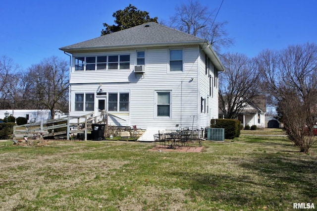 rear view of property with roof with shingles, cooling unit, a yard, a patio area, and central AC