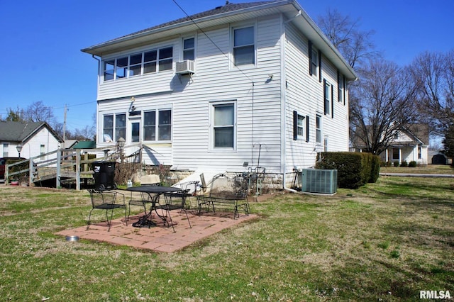 rear view of property featuring cooling unit, a patio area, a yard, and central air condition unit