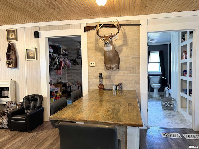 bar with wooden ceiling, wood walls, heating unit, and wood finished floors