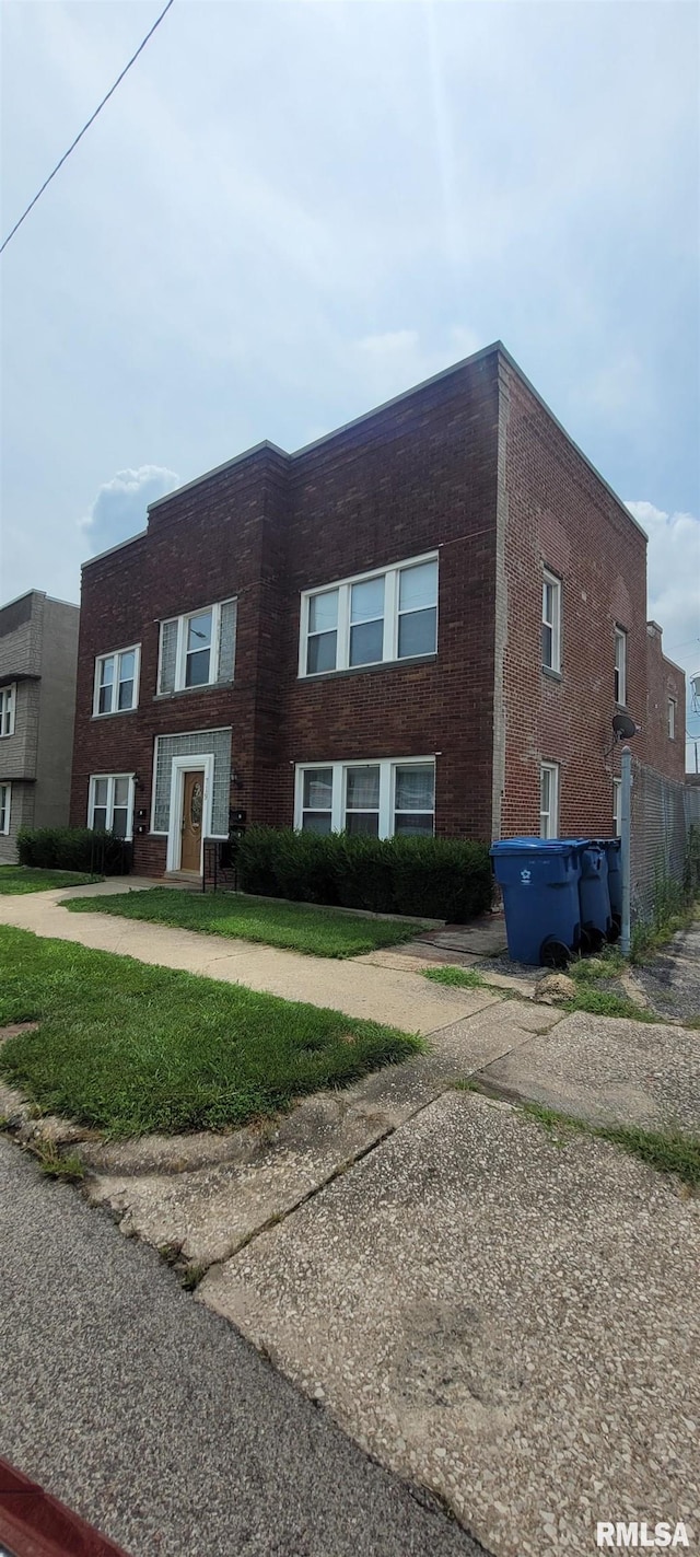 townhome / multi-family property with brick siding