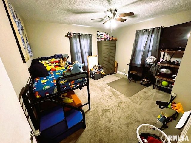 carpeted bedroom with ceiling fan and a textured ceiling