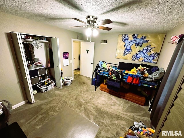 bedroom featuring carpet floors, visible vents, a textured ceiling, and a ceiling fan