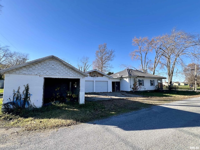 view of front facade featuring a garage and concrete block siding