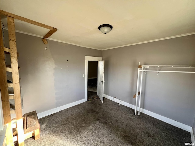 spare room with carpet floors, ornamental molding, and baseboards