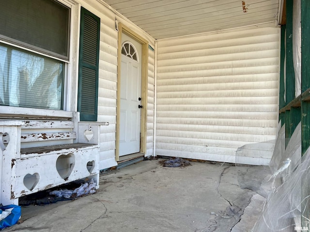 doorway to property with log veneer siding