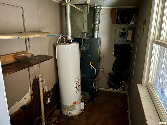 utility room with electric panel and water heater