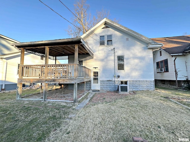 back of property with cooling unit and a lawn