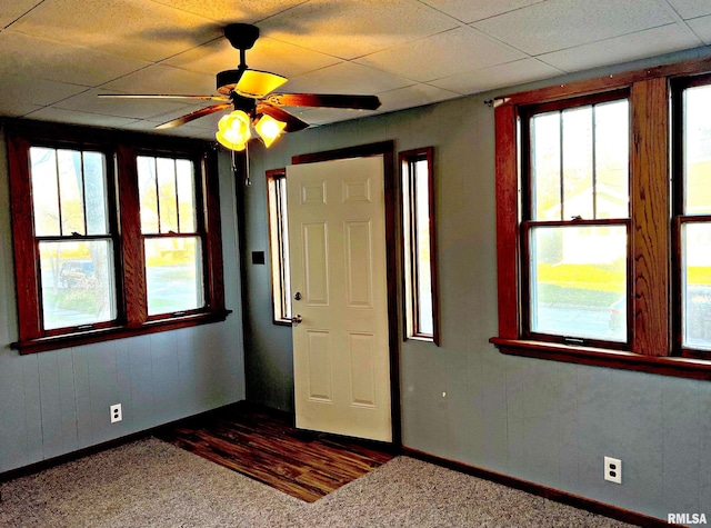 entryway featuring baseboards, wood finished floors, a paneled ceiling, and a ceiling fan