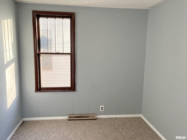 carpeted spare room with plenty of natural light and baseboards