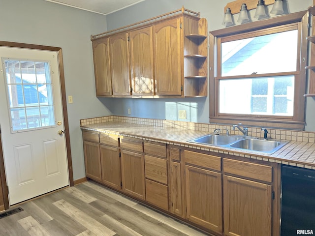 kitchen featuring a sink, visible vents, black dishwasher, a wealth of natural light, and open shelves